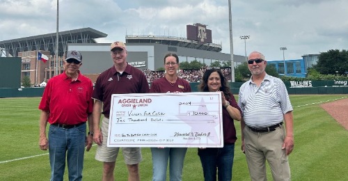Individuals Holding a Donation Check